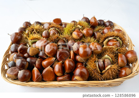 A basket full of autumn-ripened chestnuts A basket full of autumn-ripened chestnuts 128586896