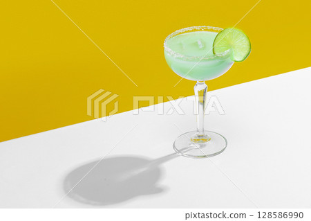 Green agave margarita cocktail with lime slice in bold summer setup Green agave margarita cocktail with lime slice in bold summer setup 128586990