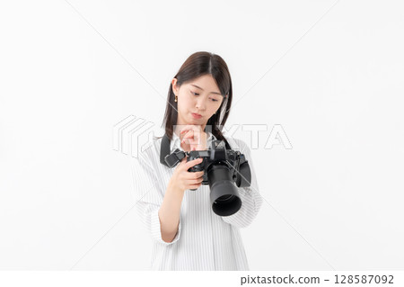 A woman with a camera A woman with a camera 128587092
