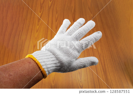 Hand in work gloves Hand in work gloves 128587551