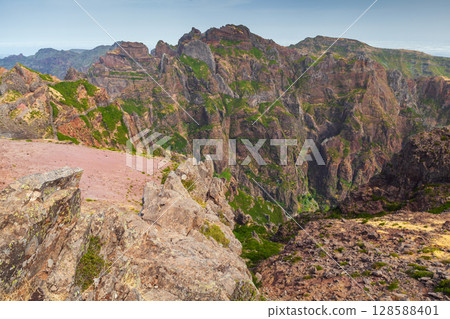 An impressive mountainous landscape featuring jagged rocky formations 128588401