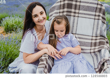 The delicate purple shade of the girl's dress echoes the color of lavender 128588803