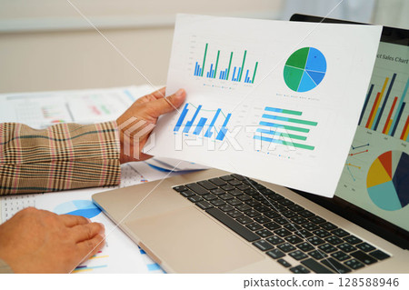 Asian business woman working with financial graph. Asian business woman working with financial graph. 128588946