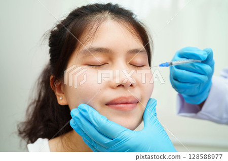 Asian woman receiving filler beauty injection. Asian woman receiving filler beauty injection. 128588977