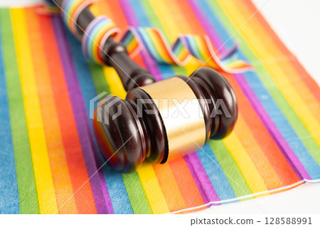 Gavel for judge lawyer on rainbow flag, symbol of LGBT pride month. Gavel for judge lawyer on rainbow flag, symbol of LGBT pride month. 128588991