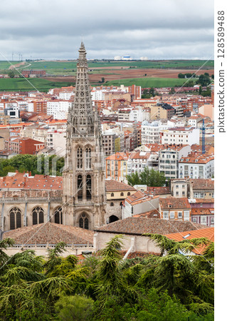 Historic Burgos Cathedral towering over the cityscape of Burgos, Spain on a cloudy day 128589488
