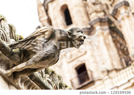 Gargoyle overlooking the historic architecture of Salamanca, Spain Gargoyle overlooking the historic architecture of Salamanca, Spain 128589506