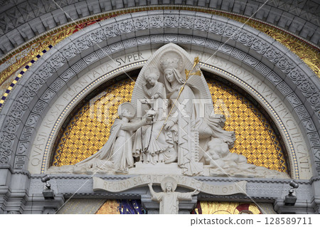 Statue of Virgin Mary in Lourdes displays intricate details and a spiritual atmosphere 128589711