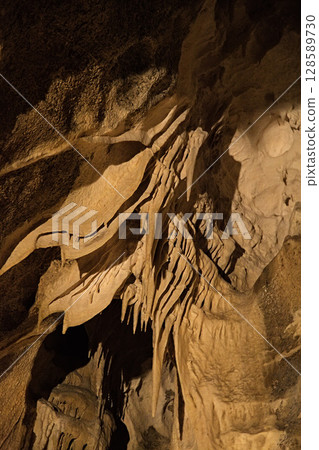 Rock formations of Betharram caves in France during a serene midday excursion 128589730