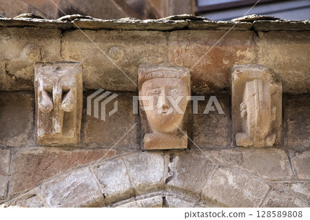Unique medieval sculptures on the facade of Abbey Church of Sainte-Foy in Conques, France 128589808