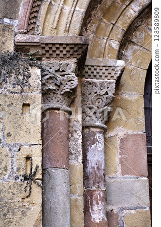Columns of Abbey Church of Sainte-Foy in Conques, France, intricate stone carvings Columns of Abbey Church of Sainte-Foy in Conques, France, intricate stone carvings 128589809