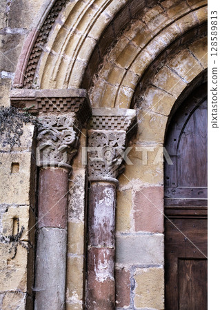 Columns of Abbey Church of Sainte-Foy in Conques, France, intricate stone carvings 128589813