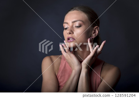 portrait of a young beautiful woman on a dark background portrait of a young beautiful woman on a dark background 128591204