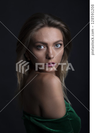 portrait of a young beautiful woman on a dark background portrait of a young beautiful woman on a dark background 128591208