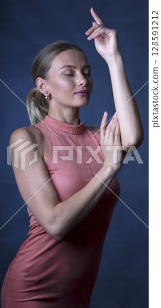 portrait of a young beautiful woman on a dark background 128591212