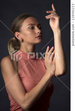 portrait of a young beautiful woman on a dark background portrait of a young beautiful woman on a dark background 128591213