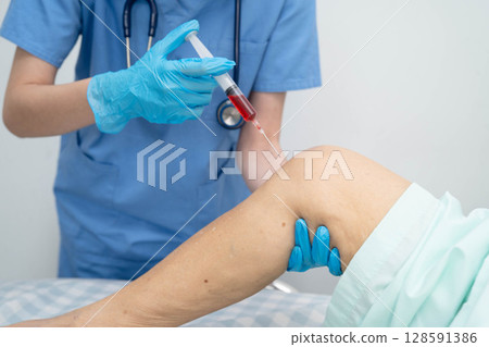 Asian doctor inject Hyaluronic acid platelet rich plasma into knee of senior woman. 128591386