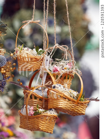 Rustic wicker baskets with dried flower decor Rustic wicker baskets with dried flower decor 128591393