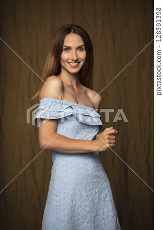 portrait of a young attractive woman on a dark background 128591398