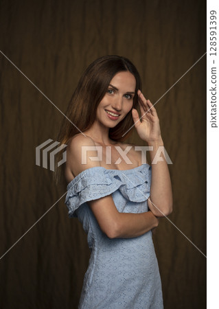portrait of a young attractive woman on a dark background 128591399