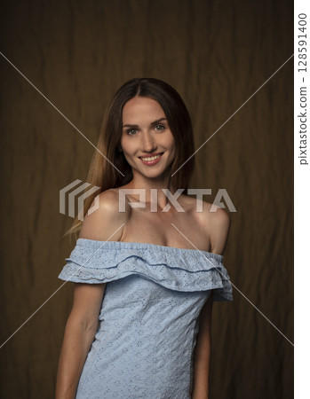 portrait of a young attractive woman on a dark background 128591400