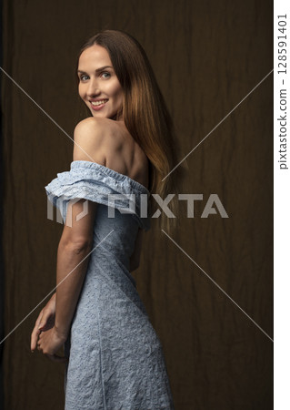 portrait of a young attractive woman on a dark background 128591401