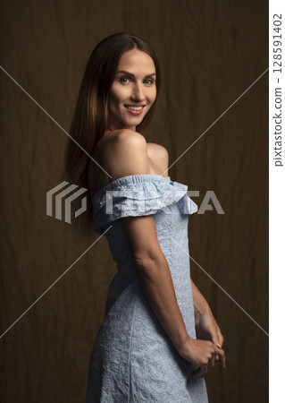 portrait of a young attractive woman on a dark background 128591402