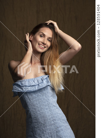 portrait of a young attractive woman on a dark background 128591404