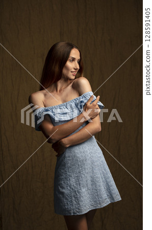 portrait of a young attractive woman on a dark background portrait of a young attractive woman on a dark background 128591405