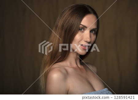 portrait of a young attractive woman on a dark background 128591421