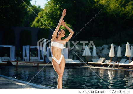 Pool is behind. Woman in white underwear Pool is behind. Woman in white underwear 128591663