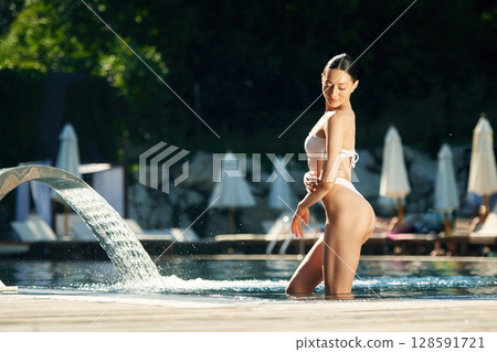 In white underwear. Woman is in the pool 128591721