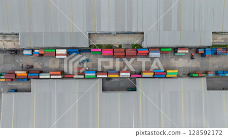 Aerial view semi truck cargo trailer at logistic park warehouse goods, Distribution warehouse shipping supply chain, Business transportation logistic freight shipping cargo by semi truck cargo 128592172