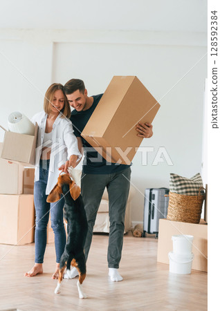 Holding boxes. Young couple moving to new home Holding boxes. Young couple moving to new home 128592384