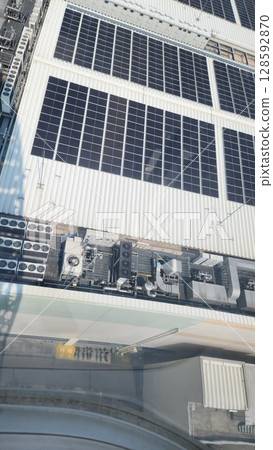 Solar panels installed above the highway 128592870