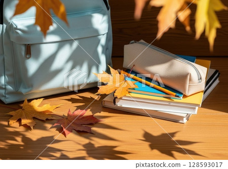 Fresh Start: New Backpack with School Supplies and Autumn Leaves 128593017