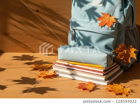 Fresh Start: New Backpack with School Supplies and Autumn Leaves 128593022