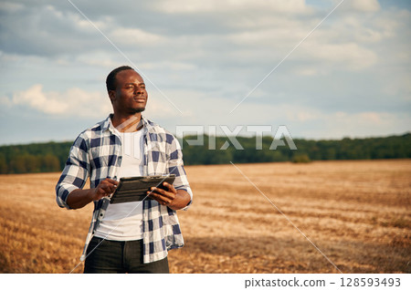 Beautiful African American man is in the agricultural field 128593493