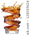 Spiral Splash of Cola in Glass Showing Motion and Energy 128593624