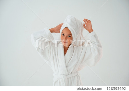 With towel on the head. Conception of beauty and self care. Young girl is in the studio 128593692