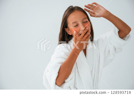 With eye patches on the face. Conception of beauty and self care. Young girl is in the studio With eye patches on the face. Conception of beauty and self care. Young girl is in the studio 128593719