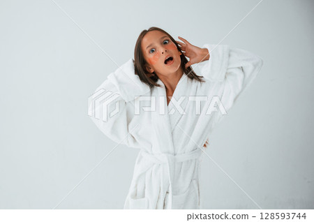 Standing and having fun. With eye patches. Conception of beauty and self care. Young girl is in the studio Standing and having fun. With eye patches. Conception of beauty and self care. Young girl is in the studio 128593744
