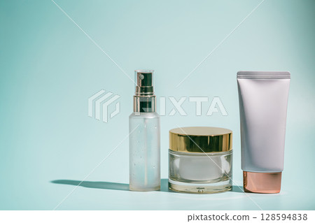 Three skincare products on blue 128594838