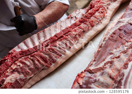 Butcher at work on his block Butcher at work on his block 128595176
