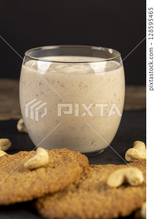 cookies and yogurt , close up, a breakfast of oatmeal cookies and a glass of yogurt cookies and yogurt , close up, a breakfast of oatmeal cookies and a glass of yogurt 128595465