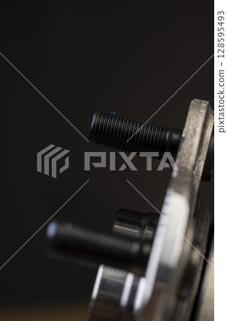 details of a steel metal part for repairing a car brake system, a part of an automobile part for fixing car wheels and repairing the chassis, wheel hub car, close up 128595493