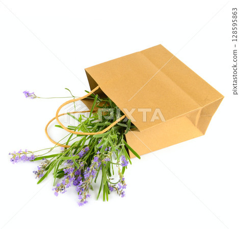 Bouquet of lavender flowers in a paper bag isolated on white. 128595863