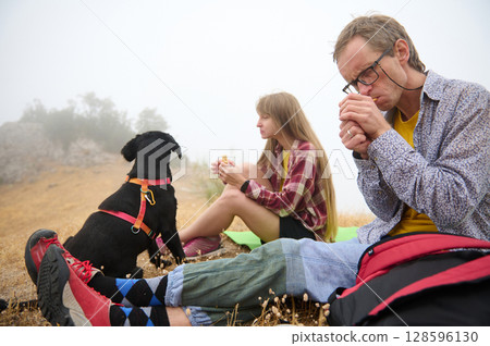 Outdoor Exploration With Friends and Dog on Foggy Day in Scenic Mountains 128596130
