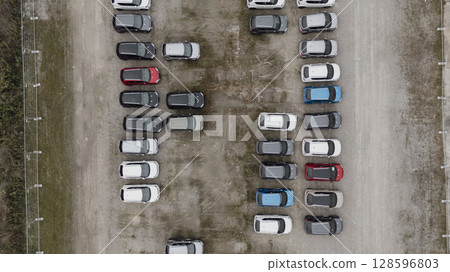 Rows of new vehicles are parked up in a holding yard waiting to be delivered to dealerships Rows of new vehicles are parked up in a holding yard waiting to be delivered to dealerships 128596803