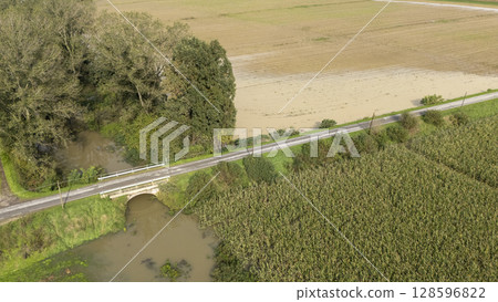 Flooded farmlands by the river swollen bursting it banks creating disasters for farmers, Italy Flooded farmlands by the river swollen bursting it banks creating disasters for farmers, Italy 128596822
